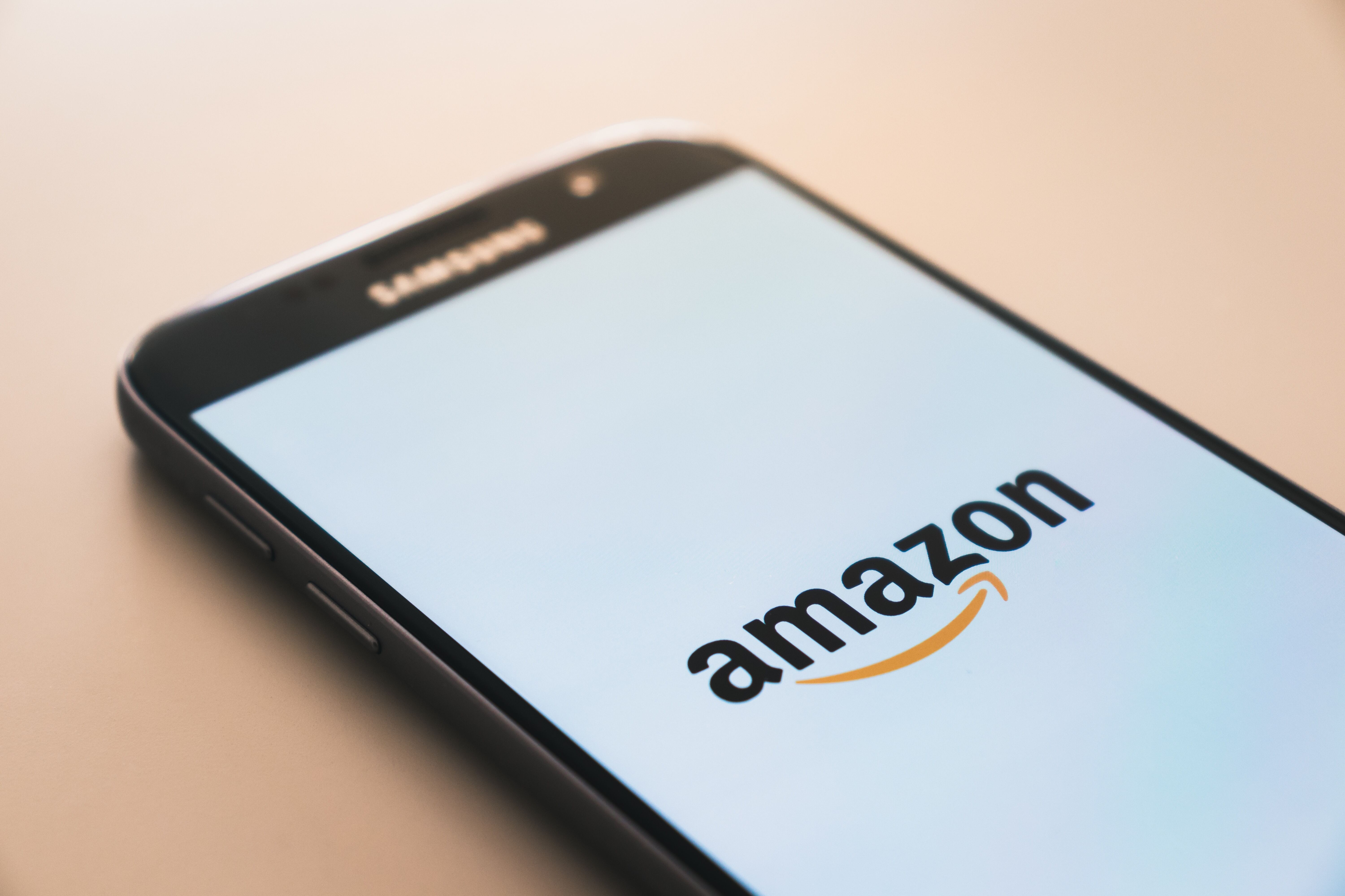 A phone screen showing Amazon logo.