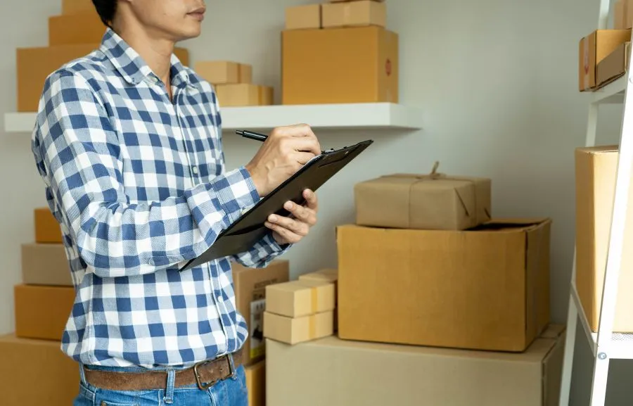 Warehouse employee thinking how to minimize excess stock.